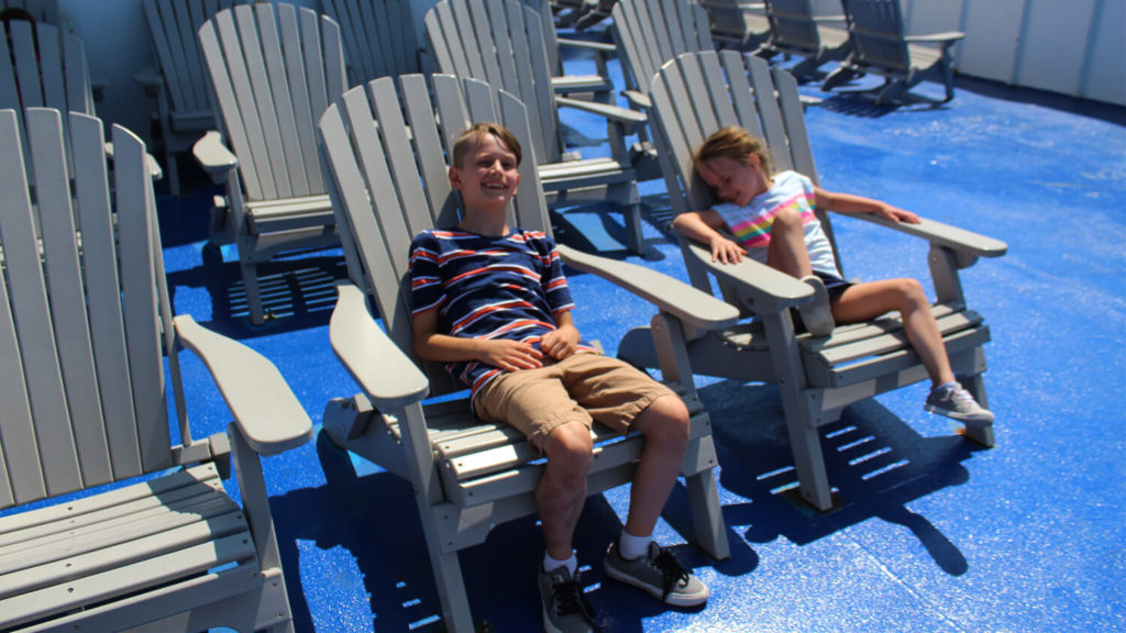 Adirondack chairs at the front of the boat
