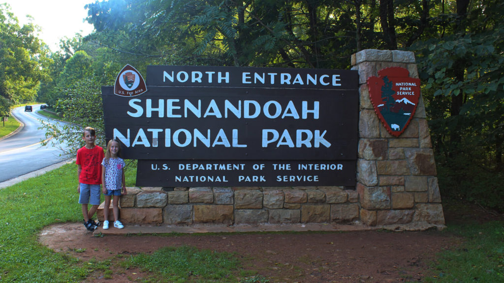 Awesome things to do in Shenandoah Valley with kids - Two kids standing in front of Shenandoah national park sign
