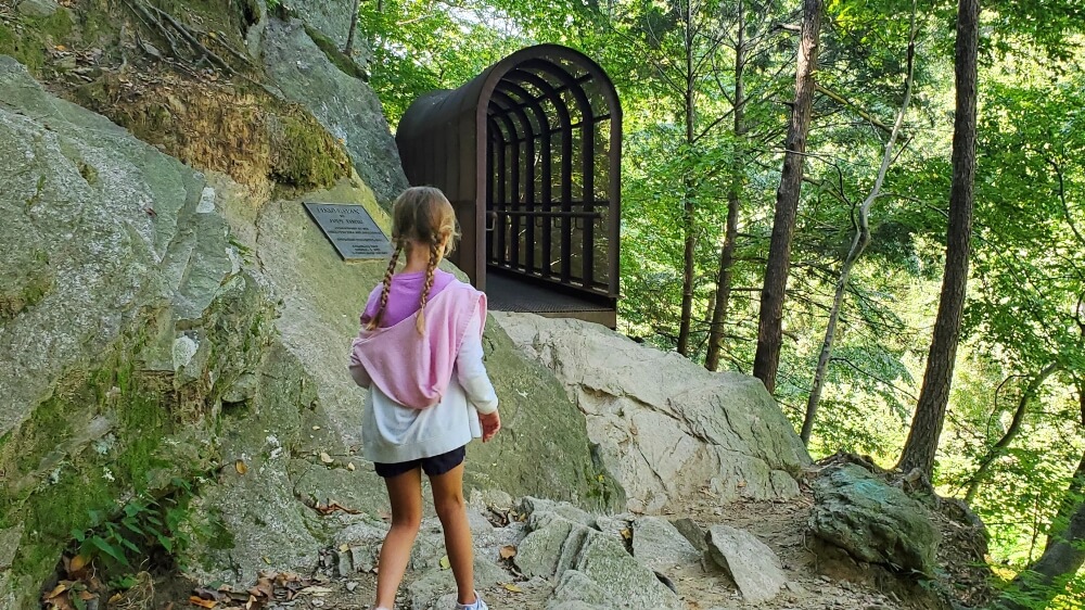 Family-Friendly hikes near Philadelphia.  Girl navigating rocky path with metal "finger span bridge" up ahead in Wissahickon Valley Park