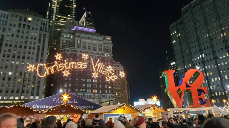 View of the Christmas Village Sign and LOVE statue at Love Park in Philadelphia at night