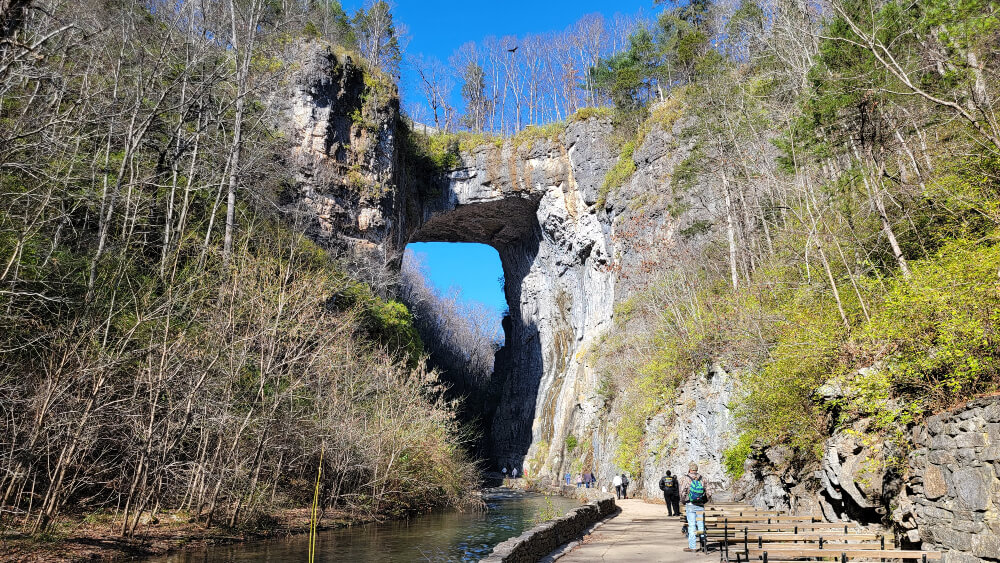 One of the best things to do in Shenandoah Valley is visit Natural Bridge - Photo of people walking under Natural Bridge in Virginia