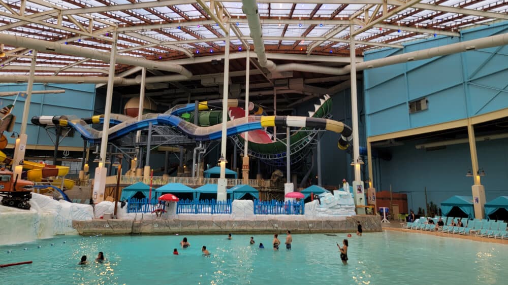 people play in the wave pool at Aquatopia at Camelback Resort with water slides in the background