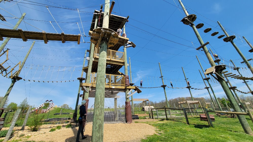 view of a three story obstacle net course with ziplines