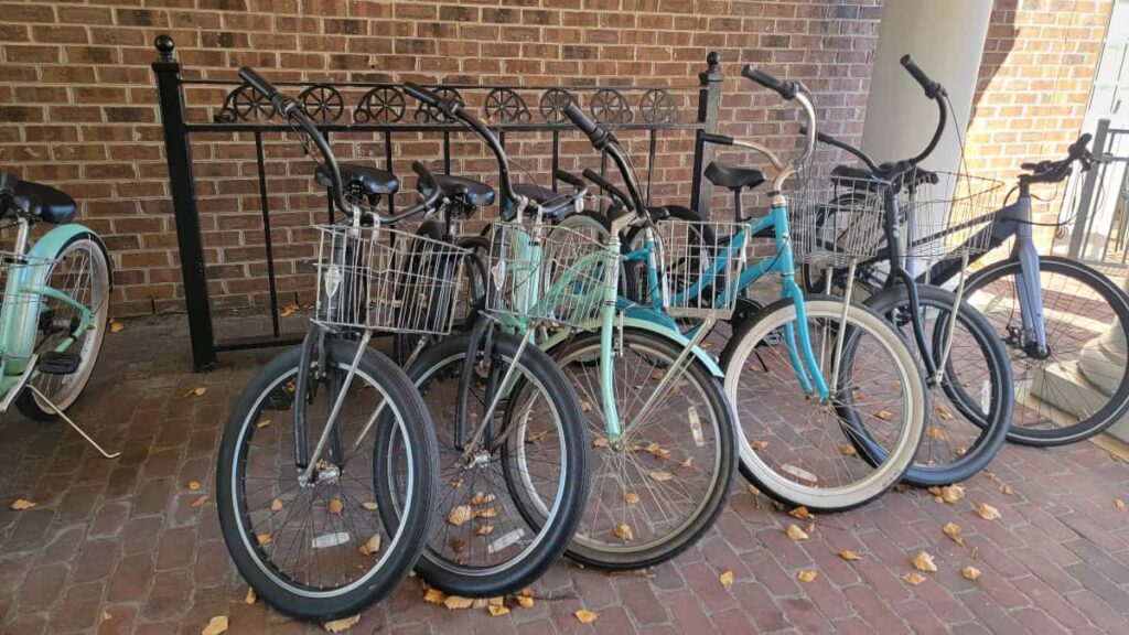 a group of bikes are lined up against a brick wall
