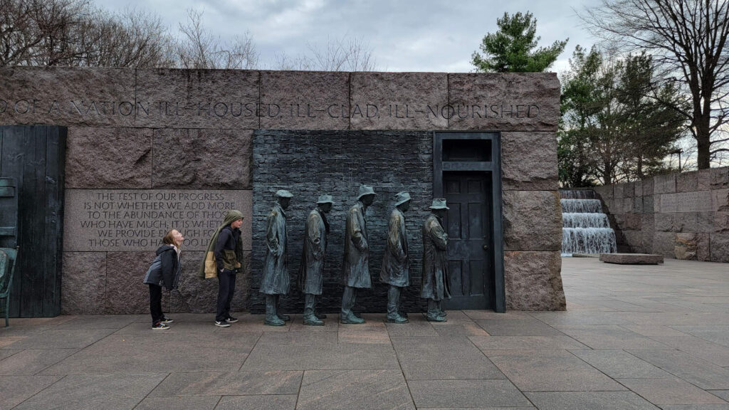 The Bread Line in Washington, DC's FDR Memorials. Two kids stand in line with the other"men".