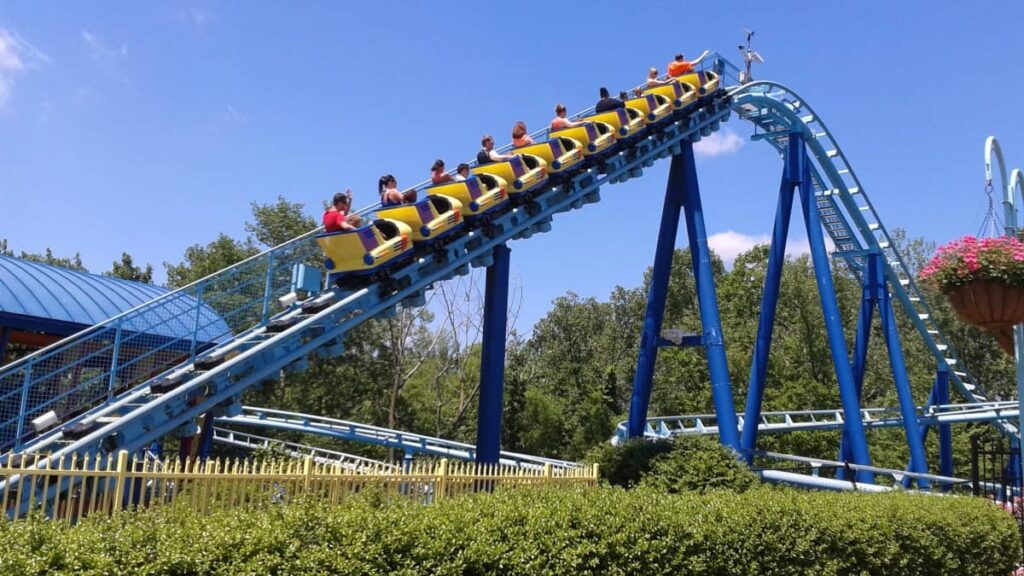 a roller coaster ascends the hill to the first drop