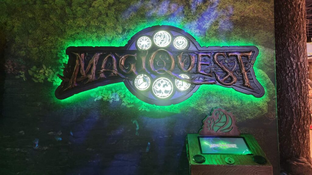 A green glowing sign reading "MagiQuest"