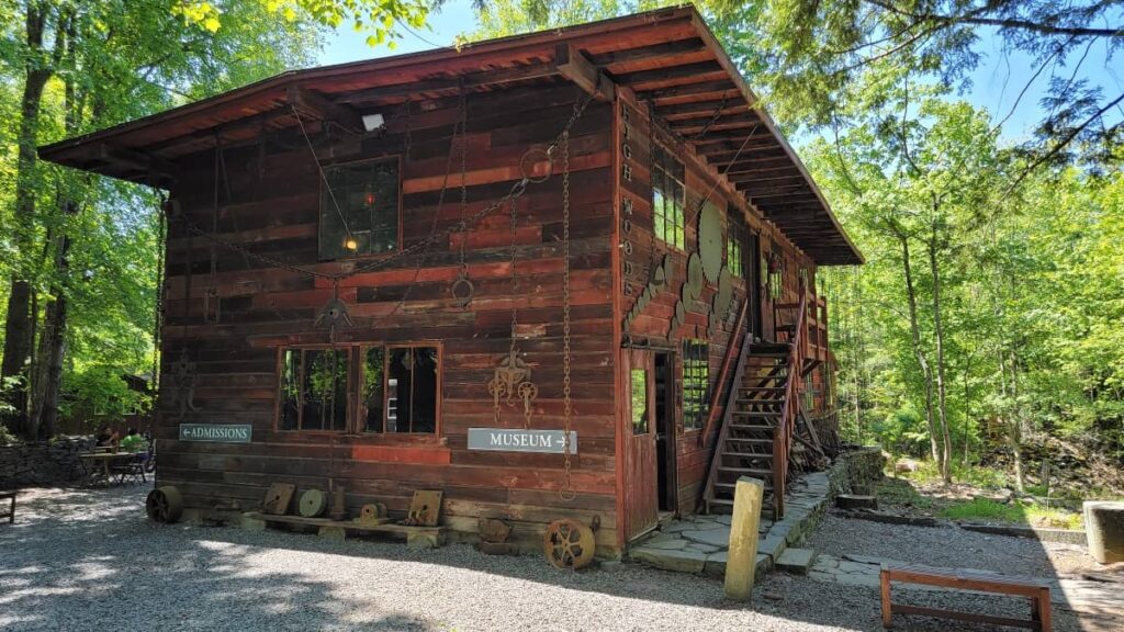 A two story wooden building serves as both a museum and gift shop at Opus40 Sculpture Park