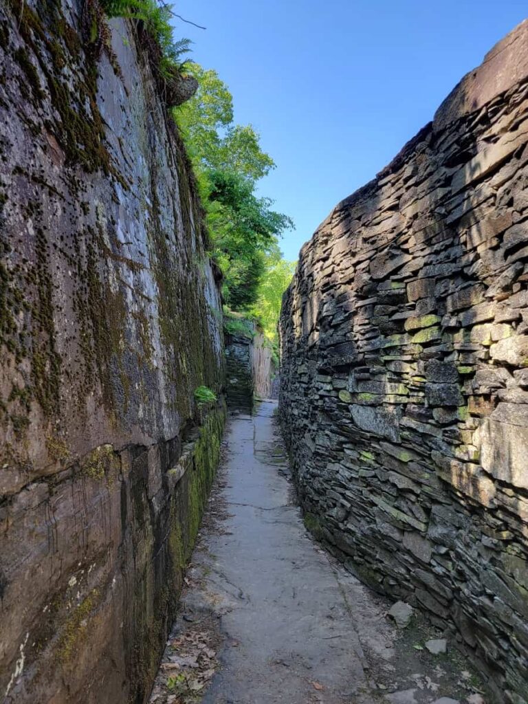a pathway meanders between to stone walls formed by stacking bluestone at Opus40