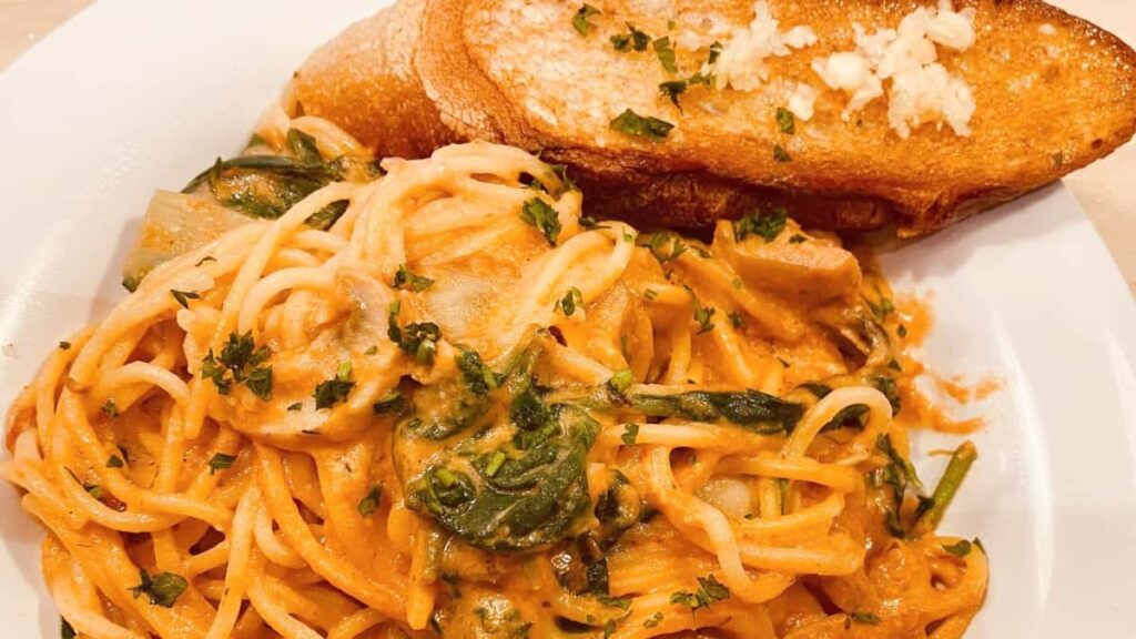 view of spaghetti with garlic bread