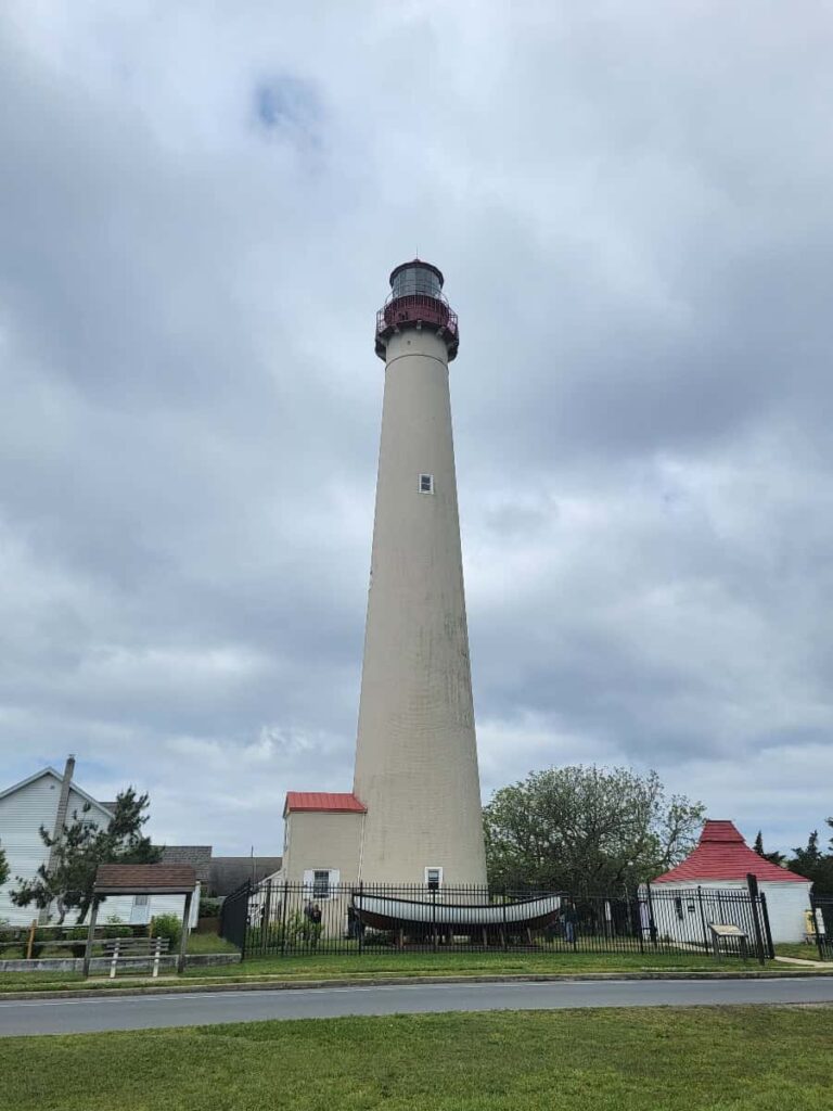 View of the Cape May Lighthouse, a 157.5 foot tall tan lighthouse with a red top