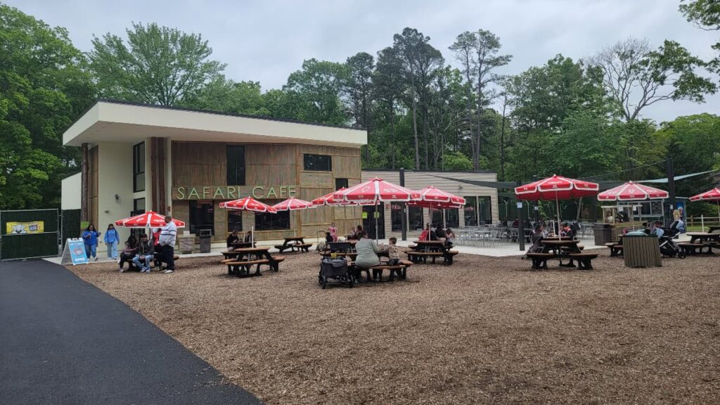 The outside of the Safari Cafe at the Cape May Zoo has several tables 