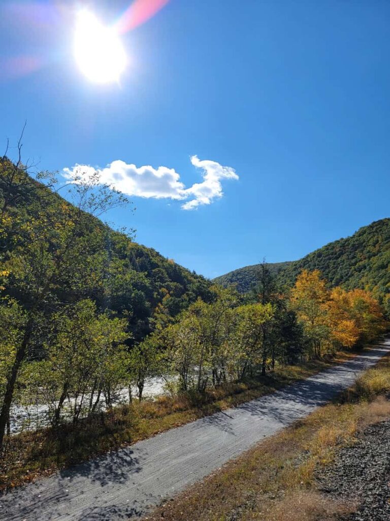 a flat wide, gravel path follows alongside the Lehigh River in Jim Thorpe