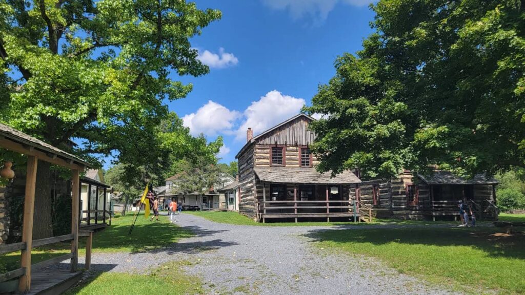 View of log cabins and gravel path through the Old Bedford Village in Pennsylvania