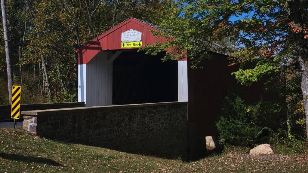 The Pine Valley Bridge has a red roof and white walls