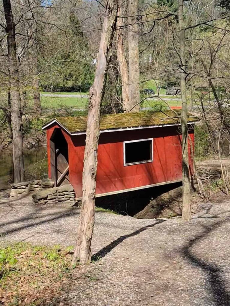 A small red covered bridge is for pedestrians only in Lorimer Park