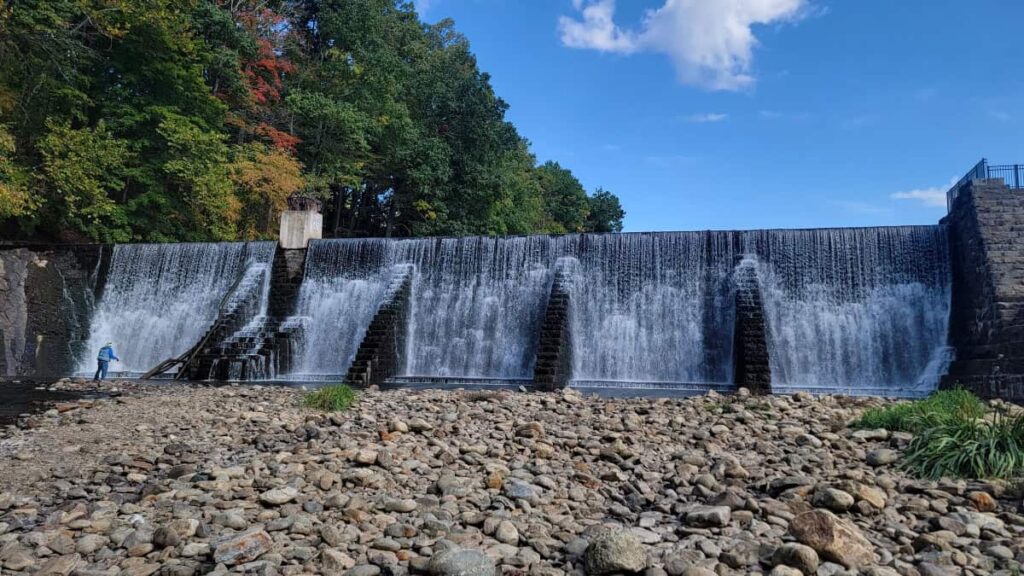 view of the lake solitude dam wall with water spilling over the side