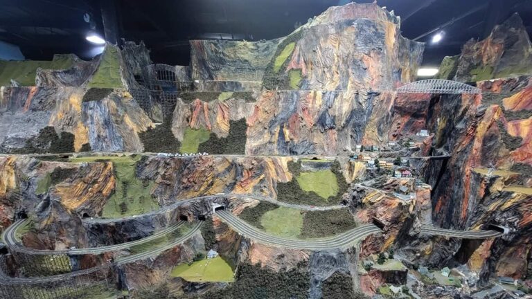 view of model train display with sculpted mountains in the back