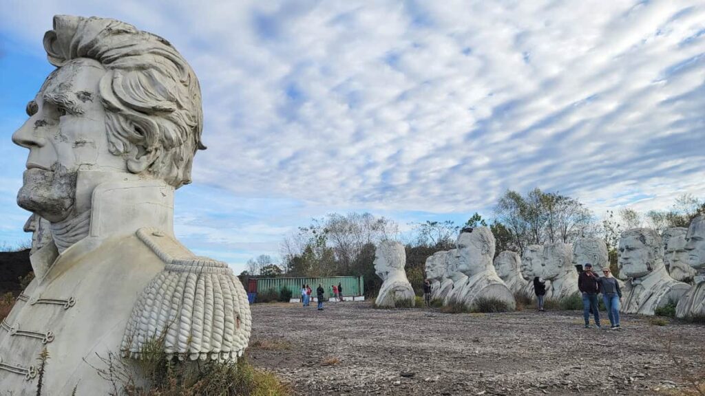 Andrew Jackson's 15 foot tall bust sits in front of other presidential sculptures in a field