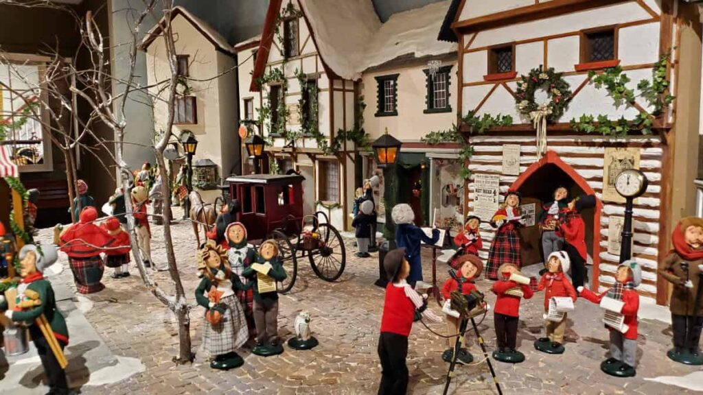 Byers Choice Christmas Museum figurines are set up in a Christmas market and town display