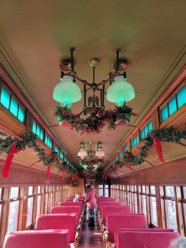 view of classic coach car at Strasburg Railroad decorated for Christmas