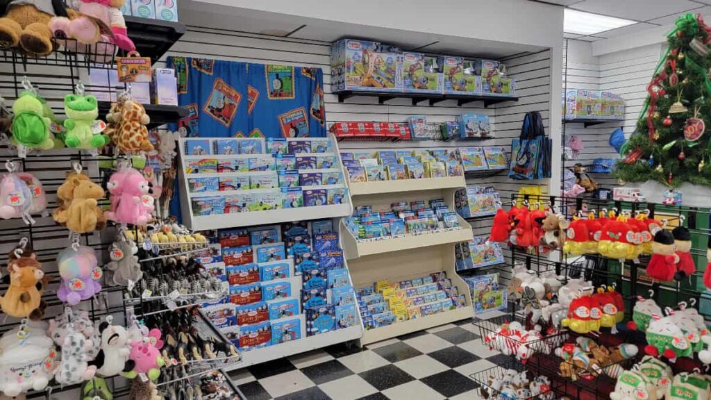 view inside a toy store of book shelves and stuffed animals
