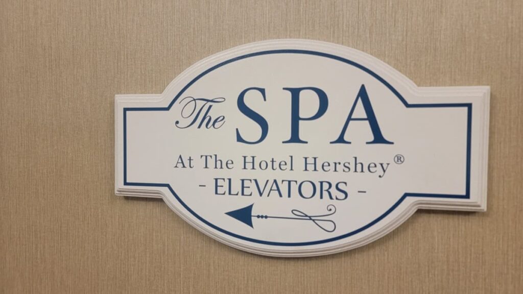 a wall sign states "the spa at the hotel hershey" and directs guests where to go