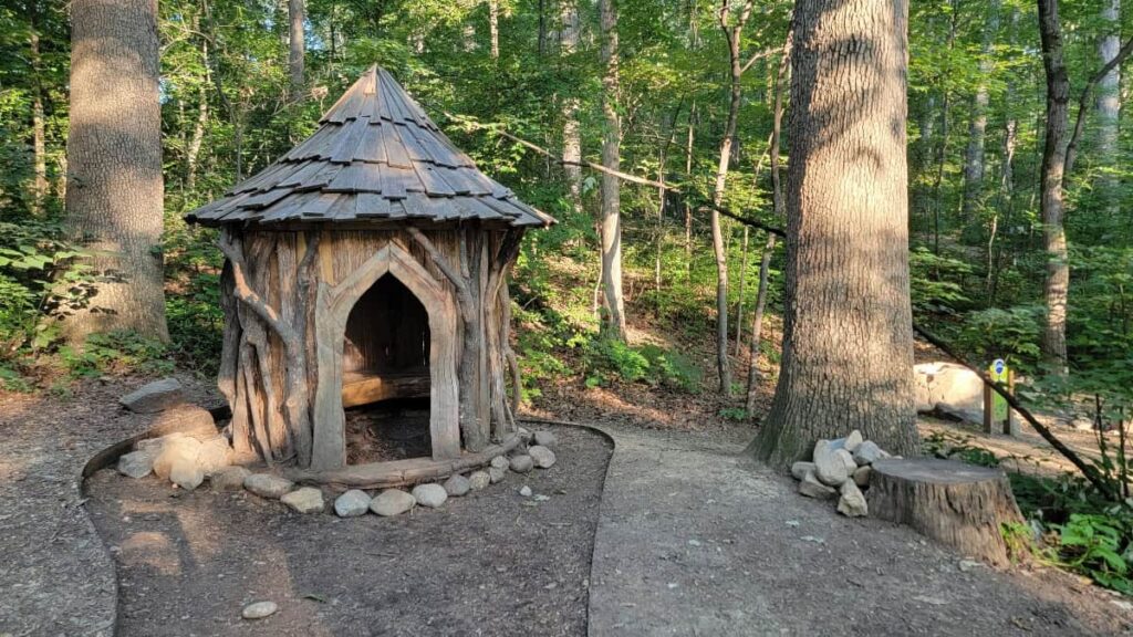 a wooden "hobbit house" sits in the wood at the Edith J Carrier arboretum at JMU